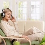 Woman sitting on a chair listening to Relaxation Therapy.